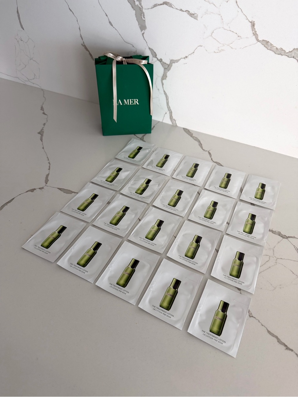 Authentic La Mer Treatment Lotion Single Use Sachets (Set of 20) and a Gift Bag
